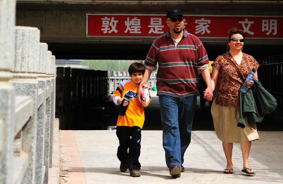 The Gilleys walk in a street in Dunhuang, northwest China's Gansu Province, April 27, 2012.