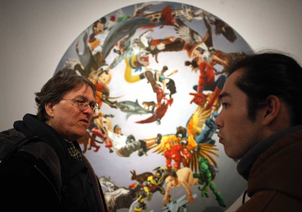 David Moser (L) discusses a drawing with his student in the 798 Art Zone in Beijing, capital of China, March 10, 2012. (Xinhua/Hou Dongtao)