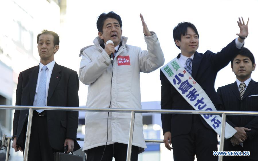 President of Japanese main opposition Liberal Democratic Party (LDP) Shinzo Abe (2nd L) delievers a speech during a campaign for December 16 lower house election in Tokyo, capital of Japan, Dec. 11, 2012. (Xinhua/Kenichiro Seki)