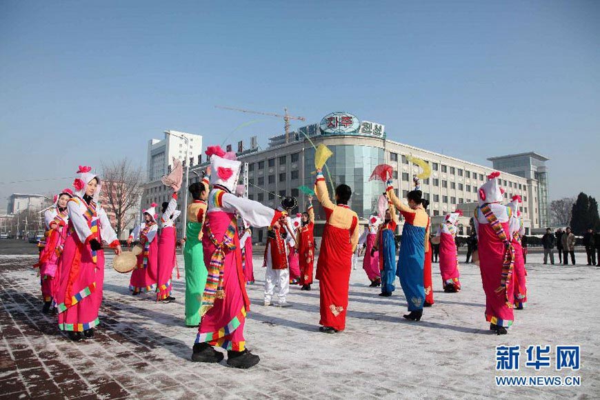 People in traditional costumes celebrate the successful launch of the long-range rocket in Pyongyang on Dec 12, 2012. Celebrations were held in the street of Pyongyang after the country successfully launched a Kwangmyongsong-3 satellite on Wednesday. (Xinhua/Zeng Tao)