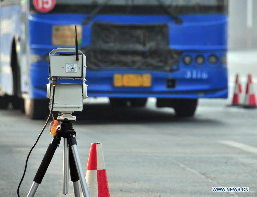 A remote emission test equipment is seen on the road in Lanzhou, capital of northwest China's Gansu Province, Dec. 12, 2012. Two vehicles with the test system have been put into operation in Lanzhou recently. The system could collet and analyse emission data from a vehicle and record the vehicle number through a remote sensoring equipment without interrupting the traffic. (Xinhua/Huang Wenxin) 