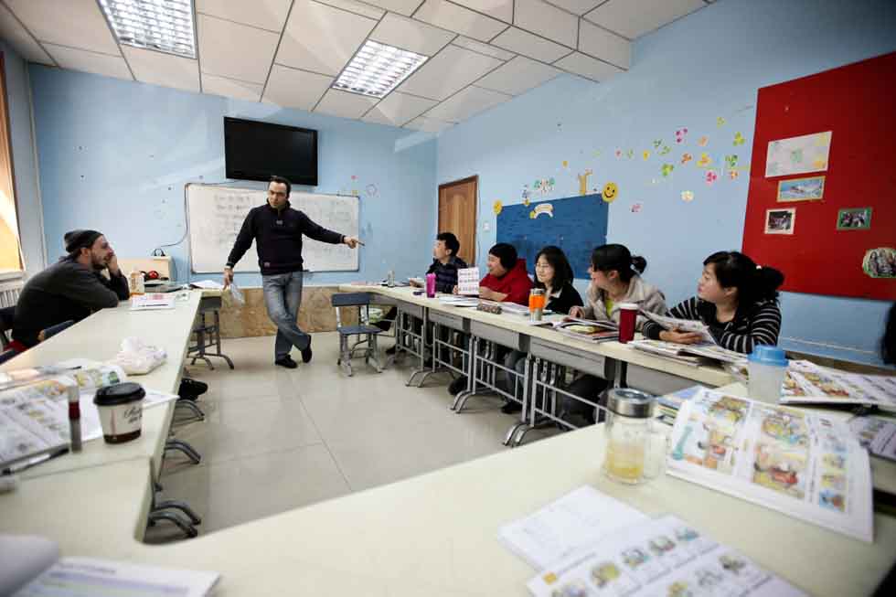 Peyam (2nd L), president of Smile English School, trains teachers at his school in Yinchuan, capital of northwest China's Ningxia Hui Autonomous Region, March 14, 2012. (Xinhua/Zheng Huansong)