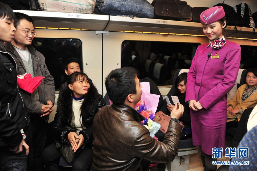 A proposal is made in a carriage of high-speed train, Feb. 5, 2012. (Xinhua)