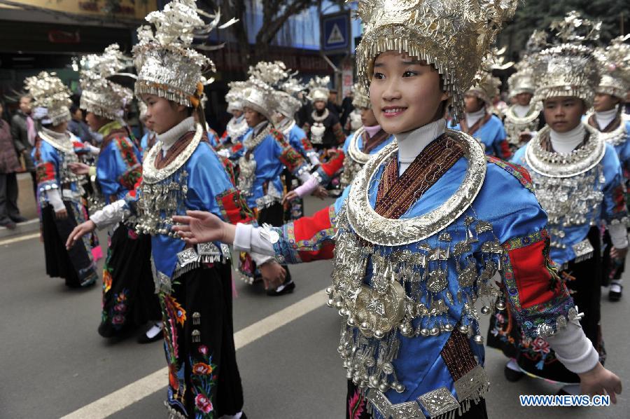 People of the Miao ethnic group take part in the Sama Festival on a street in Rongjiang County, southwest China's Guizhou Province, Dec. 18, 2012. The Sama Festival, an ancient traditional festival commemorating the woman ancestors of the Dong ethnic group, was listed as one of China's state intangible cultural heritages in 2006. (Xinhua/Ou Dongqu) 