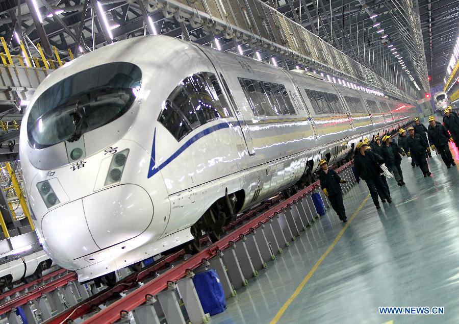 A worker checks the vehicle barn of a bullet train in Shanghai Municipality, Dec. 19, 2012. Shanghai Railway Bureau conducted a comprehensive overhaul of all the bullet trains to ensure the demand of vehicles during the coming spring rush on Wednesday. (Xinhua/Chen Fei) 