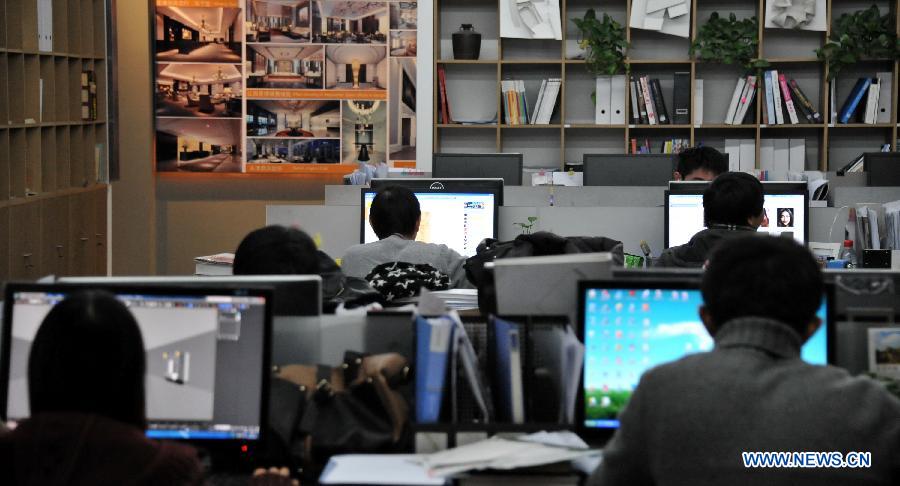 Working staff from a design company work in an office transformed from a work shop in the People's Fine Art Cultural Zone in the Banqiao South Alley of Dongcheng District in Beijing, capital of China, Dec. 19, 2012.(Xinhua/Li Xin) 