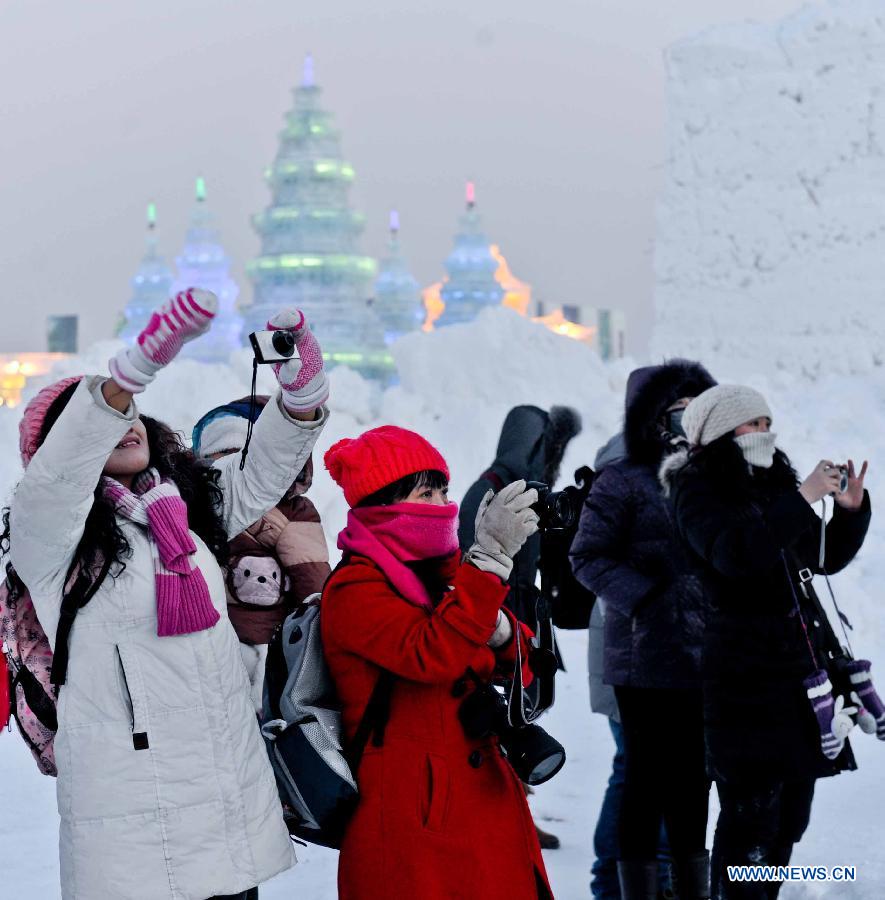 Tourists take photos of snow sculptures at the 29th Harbin International Ice and Snow Festival in Harbin, capital of northeast China's Heilongjiang Province, Dec. 23, 2012. The festival kicked off at the Harbin Ice and Snow World on Sunday. (Xinhua/Wang Song) 