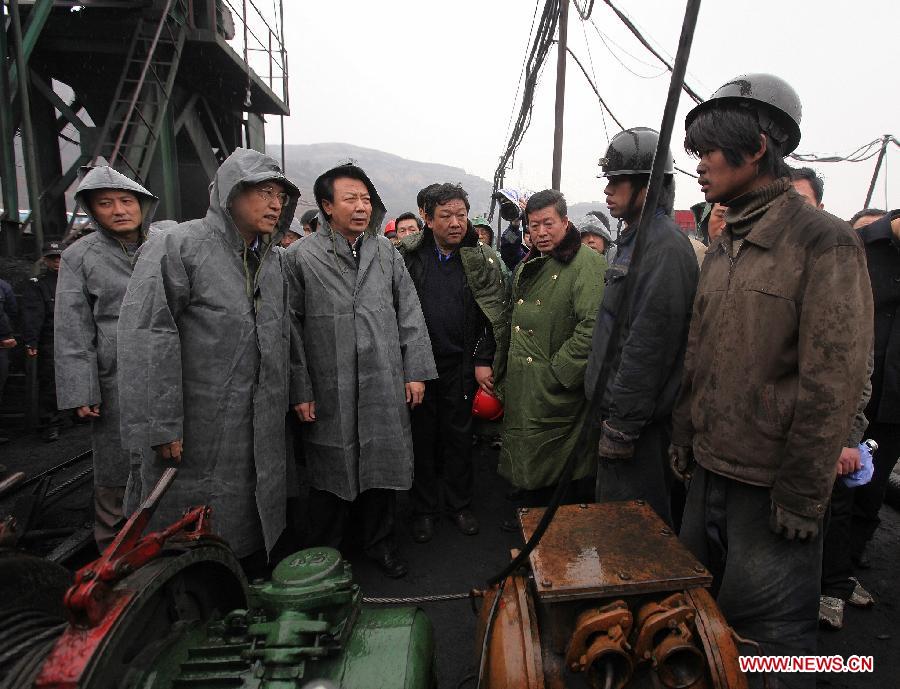 File photo taken on March 29, 2010 shows Zhang Dejiang (L, front) directs the rescue work at the site of the flooding accident of Wangjialing Coal Mine. (Xinhua/Xing Guangli) 