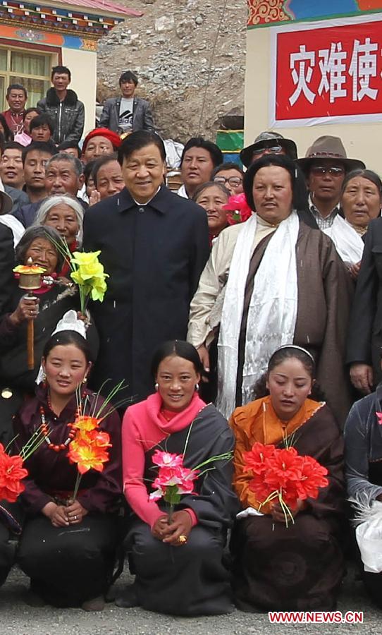 In this file photo taken on April 14, 2011, Liu Yunshan poses for a group photo with local residents as he inspects post-earthquake reconstruction projects in Jiegu Town of Yushu County, northwest China's Qinghai Province. (Xinhua/Ding Lin)  