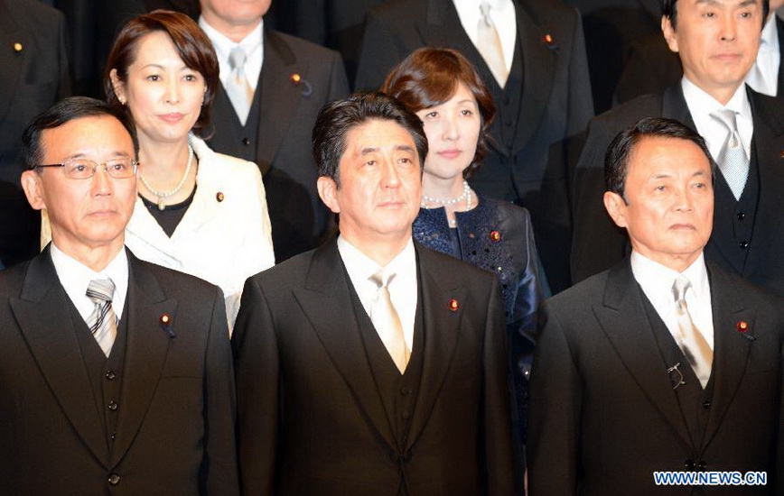 Shinzo Abe (Front C), leader of the ruling Liberal Democratic Party, poses for photos with members of a new cabinet in Tokyo, capital of Japan, on Nov. 26, 2012. Japan's new Chief Cabinet Secretary Yoshihide Suga on Wednesday announced members of a new cabinet led by Prime Minister Shinzo Abe, who just claimed the post in a special session of the Diet. (Xinhua/Ma Ping) 