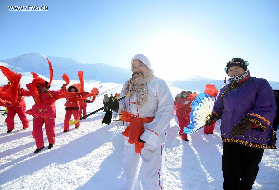 People perform traditional dance after snowfall at Jiangjunshan ski resort in Altay, northwest China's Xinjiang Uygur Autonomous Region, Dec. 28, 2012. Beautiful snow scenery here attracts a good many tourists. (Xinhua/Sadat)