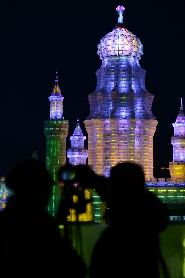 Visitors take photo of the night scenery of the Ice and Snow World during the 29th Harbin International Ice and Snow Festival in Harbin, capital of northeast China's Heilongjiang Province, Jan. 5, 2013. The festival kicked off on Saturday. (Xinhua/Wang Kai)