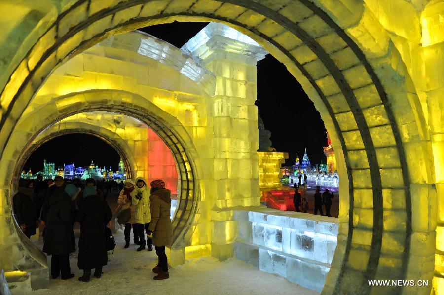 Tourists walk inside an ice sculpture in the Ice and Snow World during the 29th Harbin International Ice and Snow Festival in Harbin, capital of northeast China's Heilongjiang Province, Jan. 5, 2013. The festival kicked off on Saturday. (Xinhua/Wang Song)