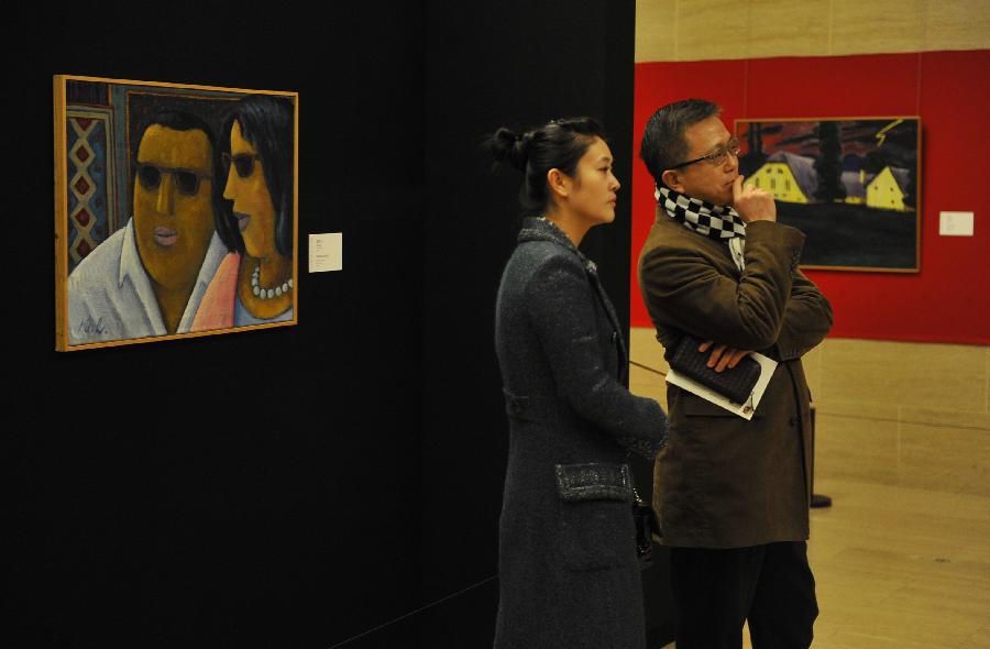 Visitors view the exhibition "Werner Berg: from Expressionism to Pop Art" in Beijing, capital of China, Jan. 5, 2013. The exhibition, which was opened at the National Art Museum of China (NAMOC) on Saturday, displays more than 70 oil paintings and 16 woodcuts created by Austrian painter Werner Berg (1904-1981). (Xinhua/Lu Peng)