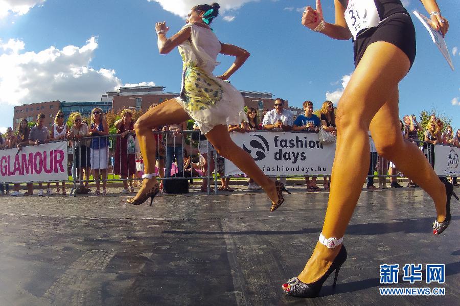 Women race in high heel shoes in Budapest, Hungary, Sept. 8, 2012. The fashion magazine “Glamour” held an annual high heel racing competition in Budapest; all the contestants were required to finish 100 meters in high heel shoes. (Xinhua/Attila Volgyi)