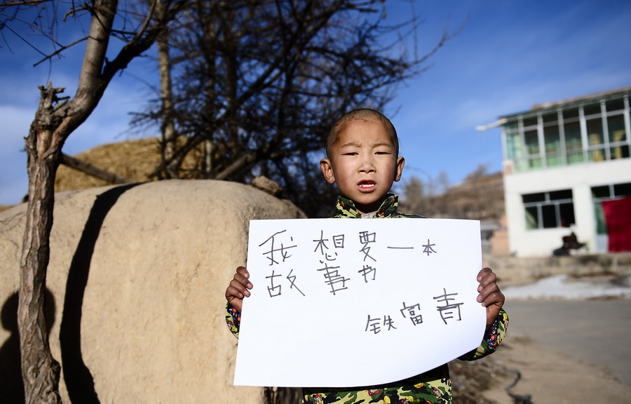 Tie Fuqing, 10, a third -grade pupil of Wanquan primary school in Datong, Qinghai. His New Year wish: I want to have a fairy story book. (Xinhua/Zhang Hongxiang)