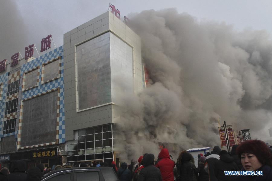 Firemen work to put out fire in a shopping mall in Harbin, capital of northeast China's Heilongjiang Province, Jan. 7, 2012. Casualty information is unknown yet after the fire started at around 9 a.m. (0100 GMT) in the Guorun Home Textiles Shopping Mall in downtown Harbin on Monday. The fire consumed an area of 9,400 square meters over the course of three and a half hours before being stopped. Firefighters helped evacuate shoppers from the five-story building. (Xinhua/Xiao Jinbiao) 