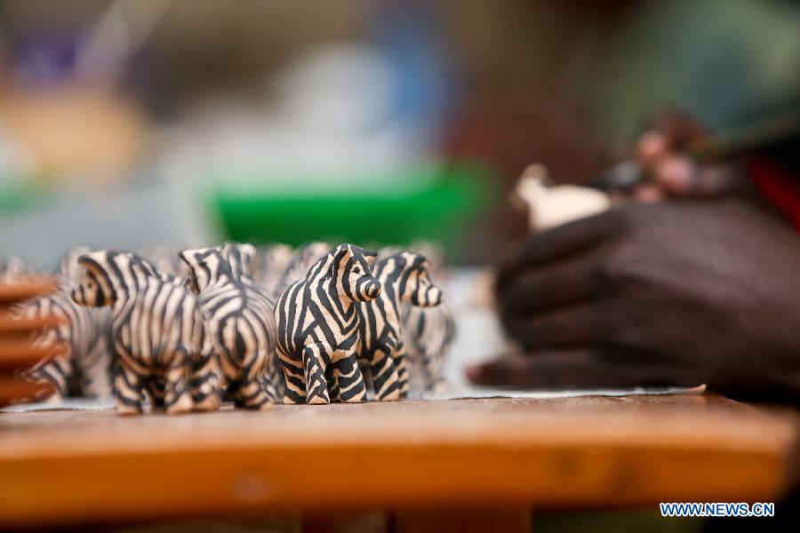 Photo taken on Jan. 8, 2013 shows zebra-shaped ceramic decorations at the Kazuri factory in Nairobi, Kenya. Kazuri, which means "small and beautiful" in Swahili, began in 1975 as a workshop experimenting on making handmade beads. The factory employs over 340 women, mostly single mothers. Its handmade and hand-painted ceramic jewellery and pottery products have been exported to over 30 countries and regions worldwide. (Xinhua/Meng Chenguang)