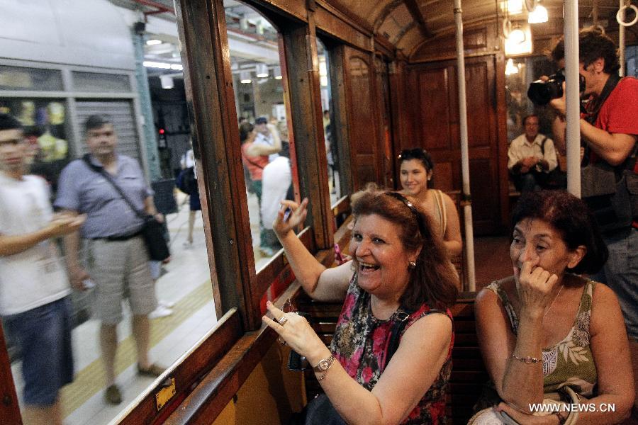 Passengers ride on a wagon of the A line subway in Buenos Aires, Argentina, on Jan. 11, 2013. The A line subway service would be closed since Jan. 12 and the Belgian original historic wooden cars, which have been in service for almost 100 years, would be repalced by upgraded Chinese-made wagons. (Xinhua/Alberto Raggio)