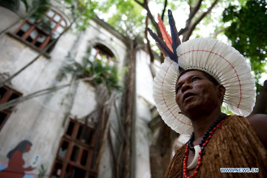 An indigenous man walks outside the old Indian Museum in Rio de Janeiro, Brazil, Jan. 16, 2013. The government of Rio de Janeiro plans to tear down an old Indian museum beside Maracana Stadium to build parking lot and shopping center here for the upcoming Brazil 2014 FIFA World Cup. The plan met with protest from the indigenous groups. Now Indians from 17 tribes around Brazil settle down in the old building, appealing for the protection of the century-old museum, the oldest Indian museum in Latin America. They hope the government could help renovate it and make part of it a college for indigenous Indians. (Xinhua/Weng Xinyang) 