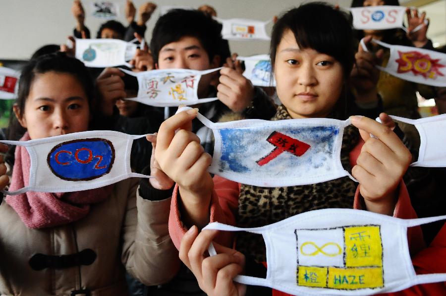 Students from the School of Fine Art of Liaocheng University present self-designed masks in Liaocheng, east China's Shandong Province, Jan. 17, 2013. A competition for mask design was held in the school to promote the ideal of environment protection and a low-carbon lifestyle. (Xinhua/Zhang Zhenxiang)