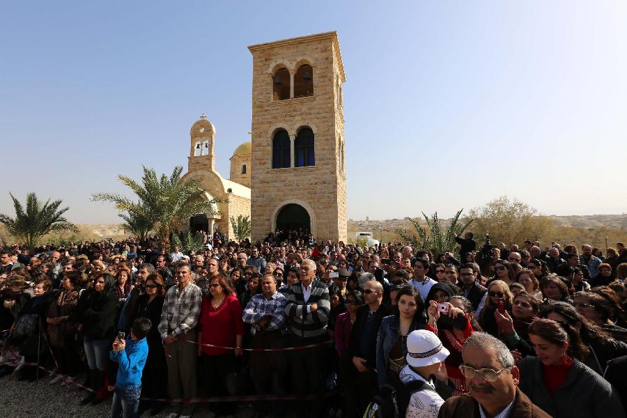 Orthodox Christian pilgrims attend a mass at a baptism site by the Jordan River on Jan. 18, 2013. Thousands of Orthodox Christians flocked to the baptism site on Friday to start a pilgrimage. (Xinhua/Mohammad Abu Ghosh) 