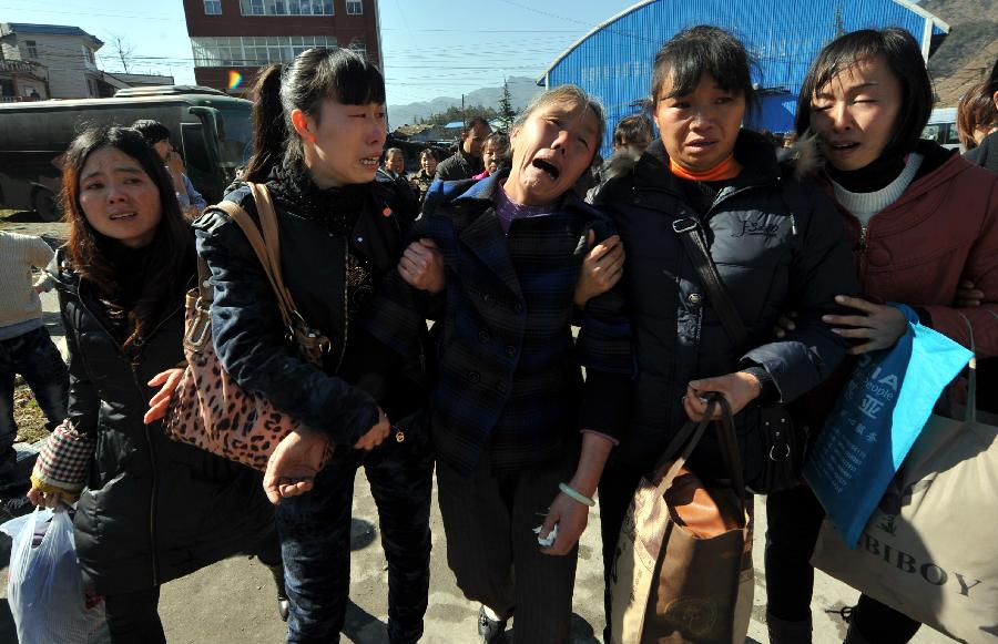 Family members of trapped miners cry outside the accident site after a coal and gas outburst occurred at the Jinjia Coal Mine under the Panjiang Investment Holding Group in southwest China's Guizhou Province, Jan. 19, 2013. The accident, which happened Friday afternoon, has left two people dead and 11 others trapped. (Xinhua/Yang Ying) 