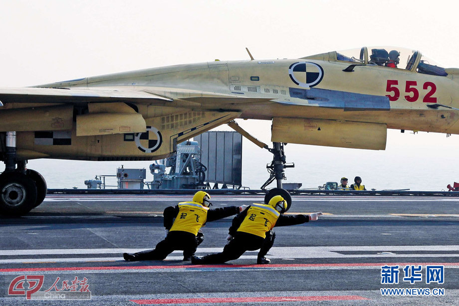 A J-15 fighter takes off from the Liaoning on Nov. 24, 2012. Recently China has successfully conducted flight landing on its first aircraft carrier the Liaoning and the crew members' gesture to give the jet take-off instruction has become very popular on the Internet. (Photo/China Pictorial)
