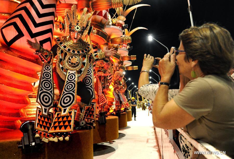 People take pictures during the Gualeguaychu Carnival parade, in Entre Rios province, Argentina, in the wee hours of Jan. 20, 2013. More than 18,000 spectators take part in the Gualeguaychu Carnival parade, which is considered to be one of the most important carnivals in Argentina. (Xinhua/Analía Garelli/TELAM) 