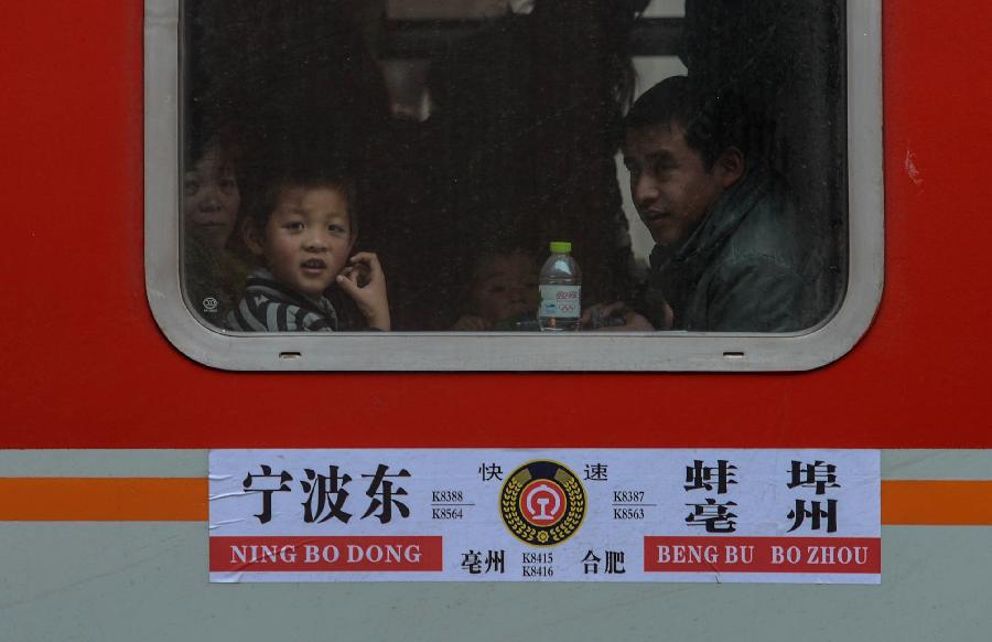 A child looks out of a window on a train from Ningbo of Zhejiang to Bengbu of east China's Anhui Province in Hangzhou, capital of east China's Zhejiang Province, Jan. 22, 2013. Many migrant workers and their children have started to return home in order to avoid the Spring Festival travel peak that begins on Jan. 26 and will last for about 40 days. The Spring Festival, the most important occasion for a family reunion for the Chinese people, falls on the first day of the first month of the traditional Chinese lunar calendar, or Feb. 10 this year. (Xinhua/Han Chuanhao)