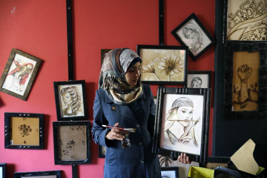 Palestinian artist Salwa Sbakhi paints using coffee at her studio in Gaza City, on Jan 22, 2013. Sbakhi has studied fine arts at Al-Aqsa University in Gaza and participated in numerous local exhibitions. (Xinhua/Wissam Nassar) 