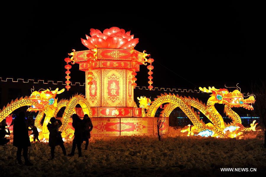 Local residents view colored lanterns on display at an ice and lantern art festival in Hengcheng scenic spot of Yinchuan, capital of northwest China's Ningxia Hui Autonomous Region, Jan. 25, 2013. The festival kicked off here on Friday. (Xinhua/Peng Zhaozhi) 