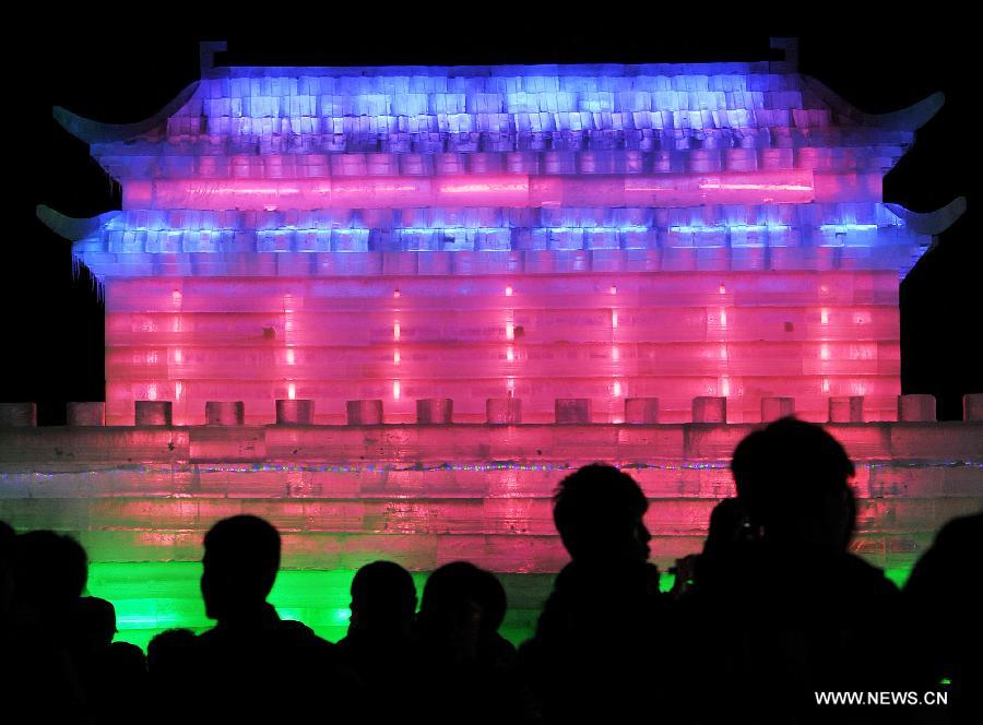 Local residents view an ice sculpture on display at an ice and lantern art festival in Hengcheng scenic spot of Yinchuan, capital of northwest China's Ningxia Hui Autonomous Region, Jan. 25, 2013. The festival kicked off here on Friday. (Xinhua/Peng Zhaozhi) 