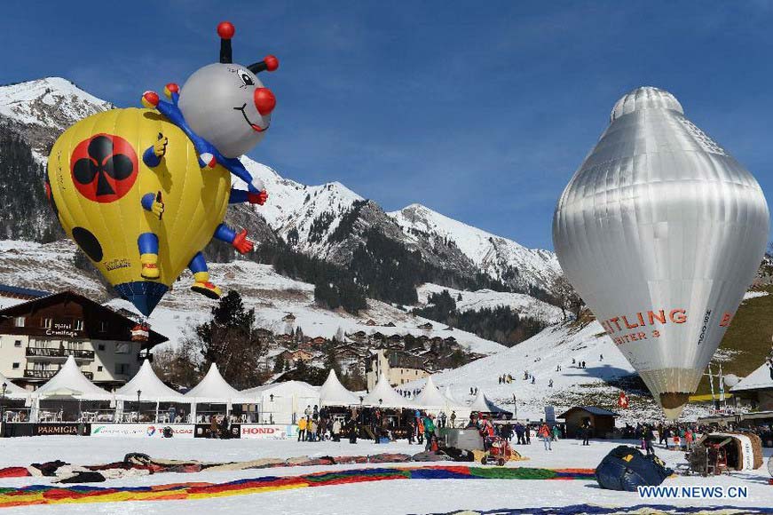 Cartoon balloons take off at the 35th International Ballon Festival in Chateau-d'Oex, Switzerland, Jan. 26, 2013. The 9-day ballon festival kicked off here on Saturday with the participation of over 80 balloons from 15 countries and regions. (Xinhua/Wang Siwei)