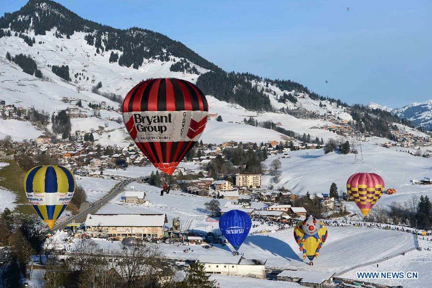 Balloons fly over Chateau-d'Oex, Switzerland, Jan. 26, 2013. The 9-day 35th International Balloon Festival kicked off here on Saturday with the participation of over 80 balloons from 15 countries and regions. (Xinhua/Wang Siwei) 