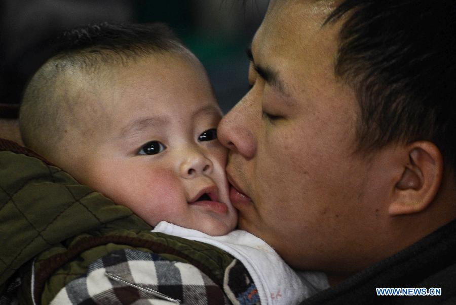 A man holds his baby tight at Hangzhou train station in Hangzhou, capital of east China's Zhejiang Province, Jan. 27, 2013. The 40-day Spring Festival travel rush began on Saturday. The Spring Festival, the most important occasion for a family reunion for the Chinese people, falls on the first day of the first month of the traditional Chinese lunar calendar, or Feb. 10 this year. (Xinhua/Han Chuanhao)