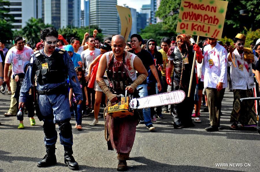 Members of the Indonesian Zombie Club (IZOC) put on zombie costumes to raise awareness of cleanness and collect donations for Jakarta residents affected by recent floods, during a rally in Jakarta, Indonesia, Jan. 27, 2013. (Xinhua/Agung Kuncahya B.)