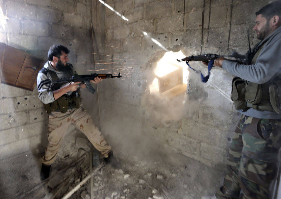 Syrian militants take cover as they exchange fire with government forces in Damascus, Syria. (Xinhua News/Reuters)