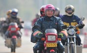 Migrant workers return home on motorcycle