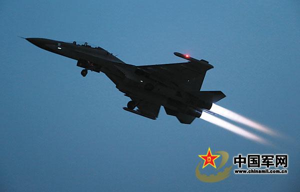 The fighters of an aviation division of the air force under the Nanjing Military Area Command (MAC) of the Chinese People's Liberation Army (PLA) took off emergently to carry out combat-readiness patrolling task on January 19, 2013. The photo shows that a fighter is in the cross-day-and-night flight training. (chinamil.com.cn/Lu Hui, Ben Daochun and Qiao Tianfu)