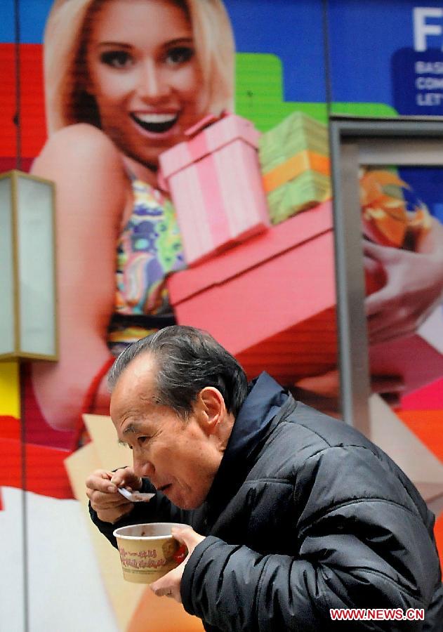 A citizen has a bowl of Laba porridge in Zhengzhou, capital of central China's Henan Province, Jan. 1, 2012. The Laba Festival, which falls on the eighth day of the 12th lunar month, is regarded as a prelude to the Spring Festival or Chinese Lunar New Year. On the day, people has a tradition to have Laba porridge which contains at least eight kinds of grains to pray for a good harvest in the coming year.Chinese people who live in the central China region have formed various traditions to celebrate the Chinese Lunar New Year. (Xinhua/Wang Song)
