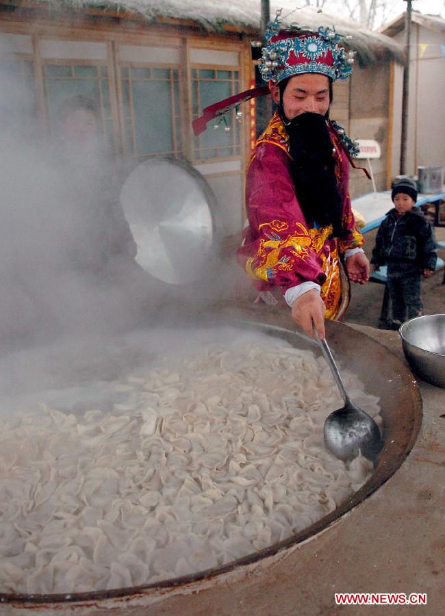 An actor acting as the Kitchen God boils dumplings for citizens during a temple fair in Zhengzhou, capital of central China's Henan Province, Jan. 28, 2006. In Chinese mythology, the Kitchen God is the most important of a plethora of Chinese domestic gods that protect the hearth and family. It is believed that on the 23rd day of the 12th lunar month, just before Chinese Lunar New Year he returns to Heaven to report the activities of every household over the past year to the Jade Emperor. The Jade Emperor, emperor of the heaven, either rewards or punishes a family based on Kitchen God's yearly report. (Xinhua/Wang Song)
