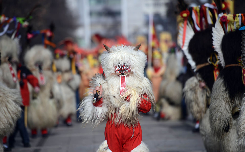 A performer carries her mask as she performs during the 22nd edition of the International Festival of Masquerade Games "Surva" in the town of Pernik, Bulgaria Saturday, Feb. 2, 2013. Some 5,000 participants take part in the festival devoted to an ancient Bulgarian pagan rite performed in the region.(Xinhua/AFP)