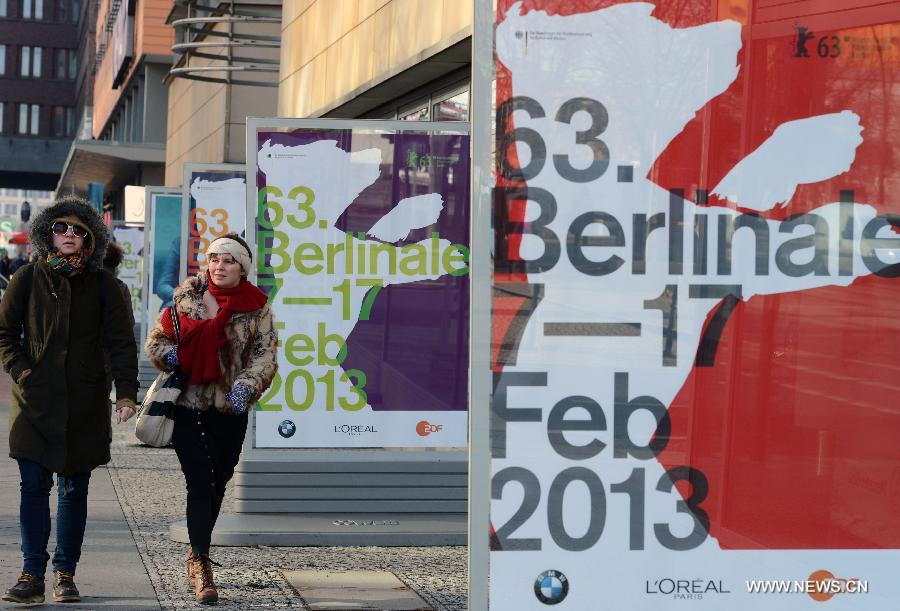 People walk past the posters of the upcoming 63rd Berlinale film festival in Berlin, capital of Germany, Feb. 6, 2013. The 63rd Berlinale film festival is scheduled to be held from Feb. 7 to 17. (Xinhua/Ma Ning)