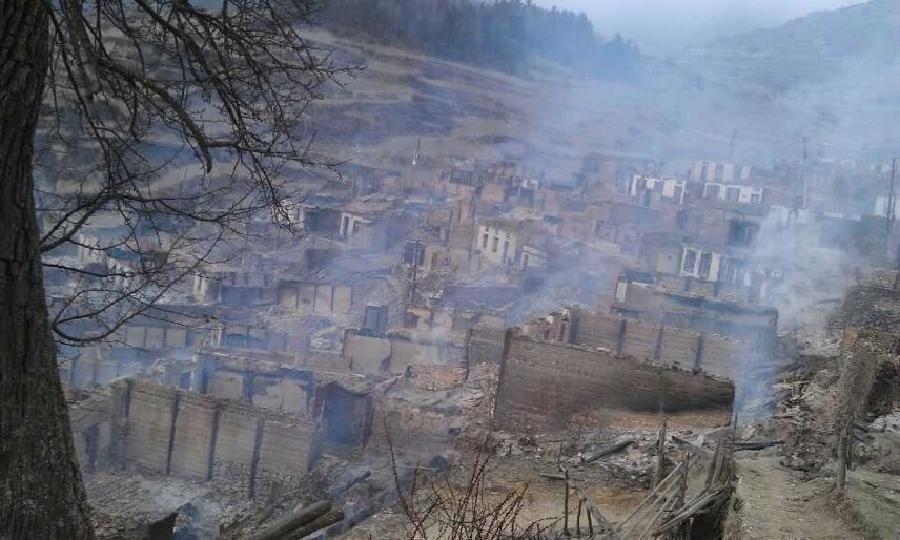 Photo taken on Feb. 7, 2013 with a cellphone shows the destroyed buildings after a fire in Heiduo Village of Diebu County in northwest China's Gansu Province. The fire broke out in Heiduo Village around 8 p.m. and was put out Thursday morning, leaving destruction of 92 homes and no casualties. (Xinhua/Niu Zhien)