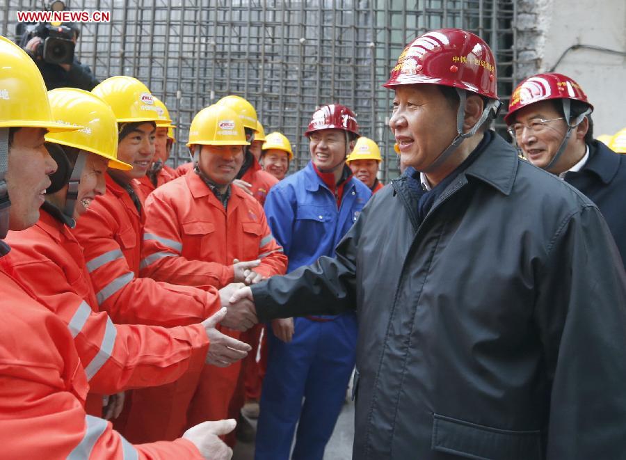 Xi Jinping (R Front), general secretary of the Communist Party of China (CPC) Central Committee and chairman of the CPCP Central Military Commission, meets with workers at the construction site of the Nanluoguxiang station of subway line 8 in Beijing, capital of China, Feb. 8, 2013. Xi Jinping on Friday visited and extended greetings to laborers including subway construction workers, sanitation workers, police officers and taxi drivers in Beijing, ahead of the Chinese traditional Spring Festival, which starts on Feb. 10 this year. (Xinhua/Ju Peng) 