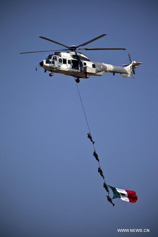 Members of the Mexican Air Force perform air acrobacies as part of an exhibition during a ceremony to commemorate the 98th anniversary of the Mexican Air Force, held at the Santa Lucia Military Air Base in Santa Lucia, Tecamac, State of Mexico, on Feb. 10, 2013. (Xinhua/Rodrigo Oropeza) 