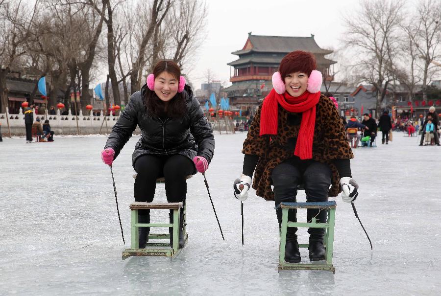 Tourists ride sleds at the Shichahai Lake Ice Rink on the first day of the Chinese Lunar New Year in Beijing, capital of China, Feb. 10, 2013. Many people here chose to spend the first day of the Chinese Lunar New Year on the ice. (Xinhua/Chen Xiaogen) 