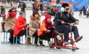 Tourists ride sleds at Shichahai Lake Ice Rink