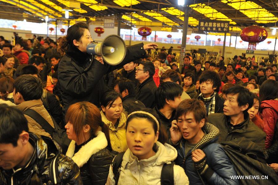 Passengers enter Guiyang Railway Station in Guiyang, capital of southwest China's Guizhou Province, Feb. 15, 2013. China's railways will be tested Friday, when passenger flows peak at the end of the Spring Festival holiday. Some 7.41 million trips will be made on the country's railways with travelers returning to work as the week-long Lunar New Year celebration draws to a close, the Ministry of Railways said. (Xinhua/Ou Dongqu)  